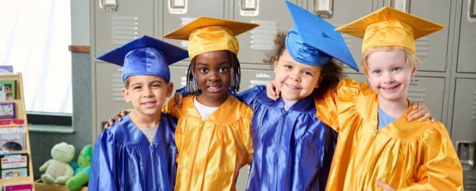 New Horizon Academy pre-kindergarten graduates wearing graduation caps and gowns and getting ready for kindergarten