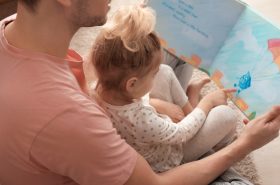 Father reading a book with his toddler child